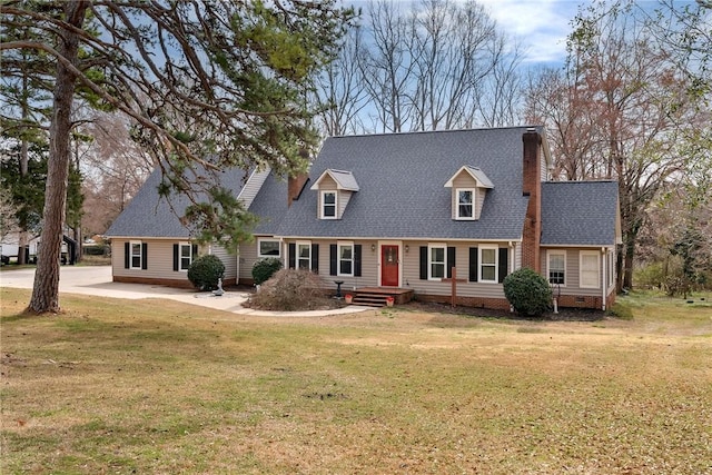 new england style home with crawl space, a shingled roof, a chimney, and a front lawn