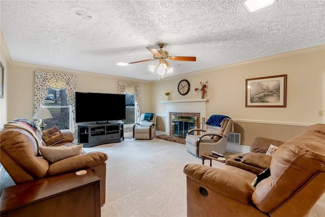 living area featuring light colored carpet, visible vents, a ceiling fan, ornamental molding, and a brick fireplace