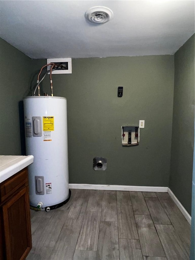 utility room with water heater and visible vents