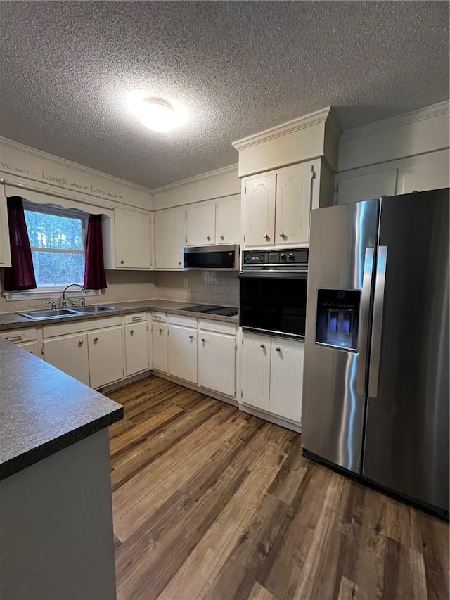 kitchen featuring dark wood-style floors, black appliances, a sink, and white cabinetry