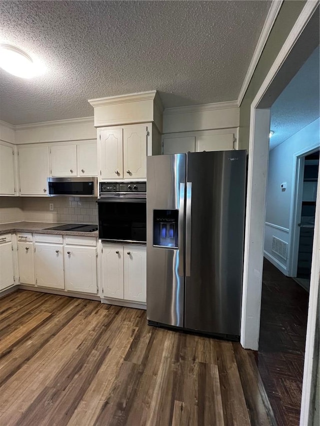 kitchen with black appliances, dark wood-type flooring, white cabinetry, and crown molding