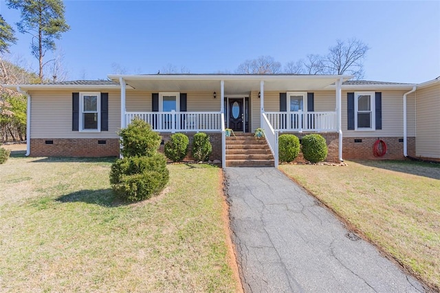 ranch-style home featuring crawl space, covered porch, and a front yard