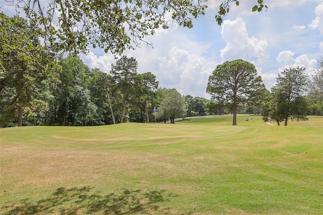 view of home's community featuring a lawn and golf course view