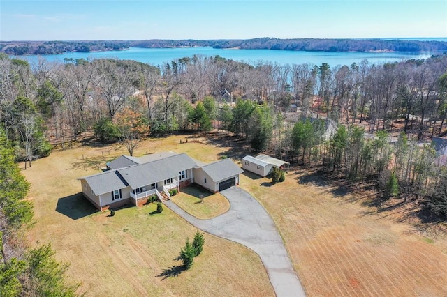 aerial view with a water view and a view of trees