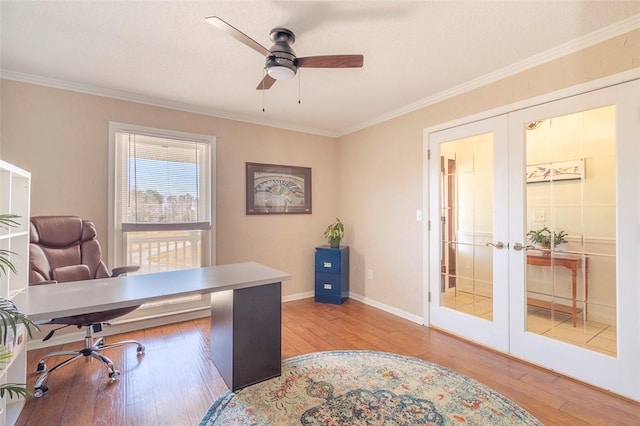 home office with baseboards, wood-type flooring, ceiling fan, crown molding, and french doors