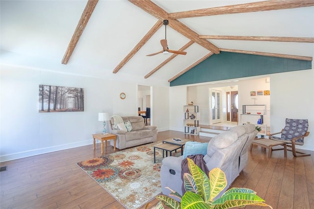 living area featuring baseboards, wood-type flooring, a ceiling fan, and beamed ceiling