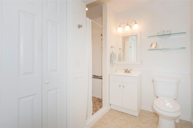 bathroom featuring vanity, a closet, a tile shower, and toilet