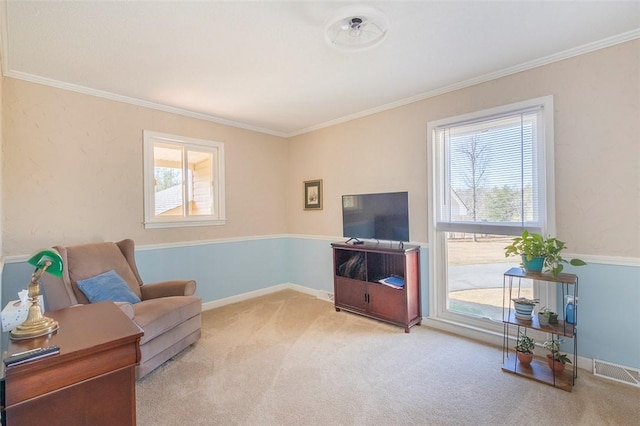 living area with ornamental molding, carpet, visible vents, and a healthy amount of sunlight