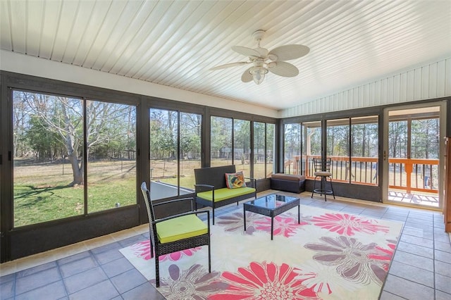 sunroom featuring plenty of natural light and a ceiling fan