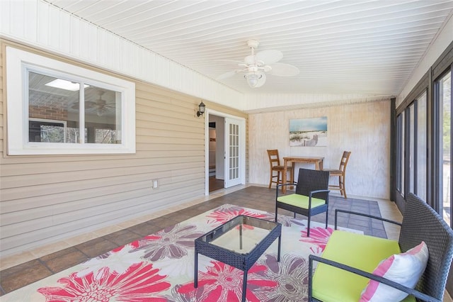 sunroom / solarium featuring ceiling fan