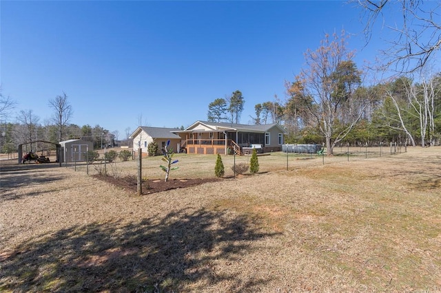 view of front of home featuring covered porch, fence, and a front lawn