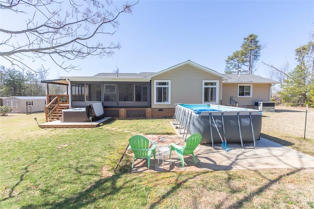 rear view of property featuring a patio, a sunroom, crawl space, a jacuzzi, and an outdoor pool