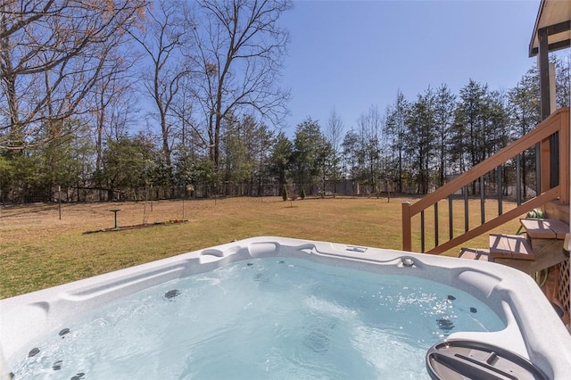 view of pool with a lawn, fence, and a hot tub