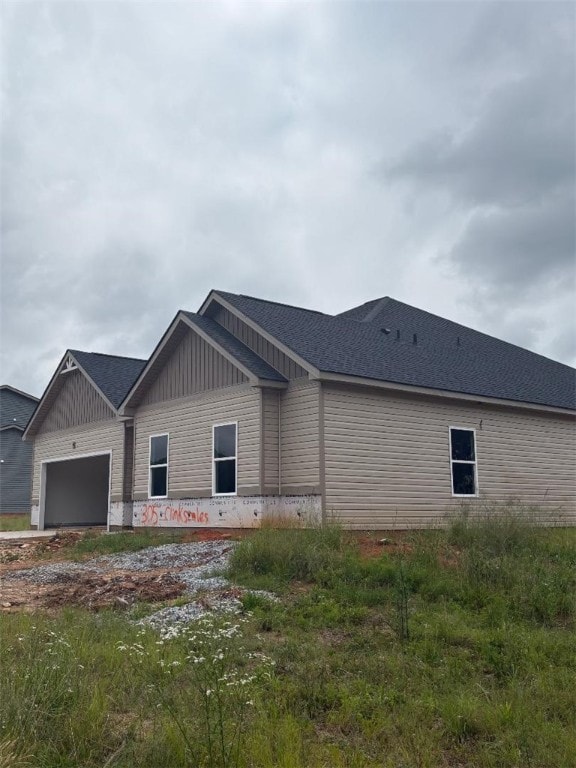 305 Clinkscales Rd, Anderson, SC 29624 - view of side of home featuring an attached garage, board and batten siding, and a shingled roof