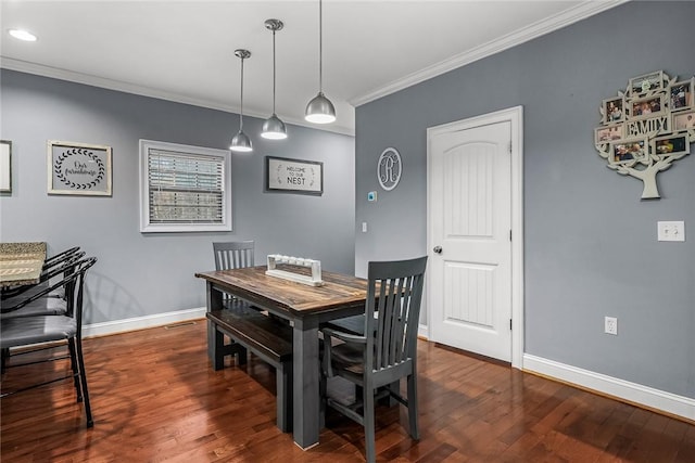 dining area with dark wood finished floors, visible vents, crown molding, and baseboards