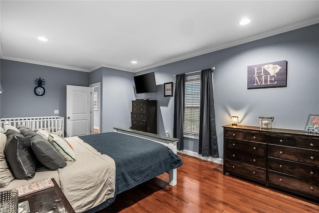 bedroom with recessed lighting, crown molding, baseboards, and wood finished floors