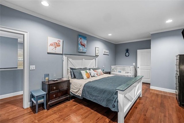 bedroom with crown molding, baseboards, wood finished floors, and recessed lighting