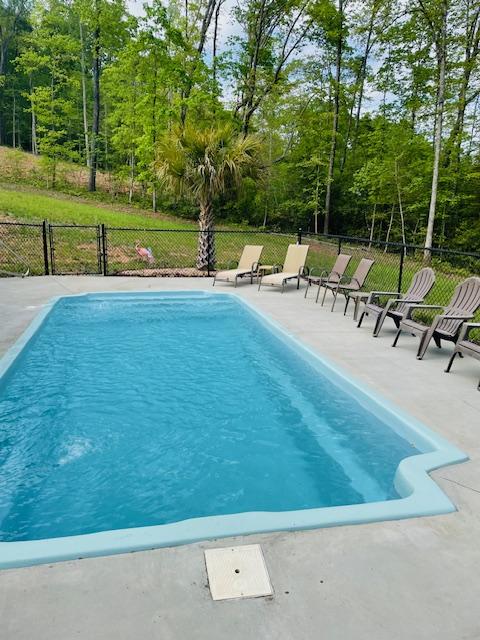 view of swimming pool with a fenced in pool, a patio area, and fence