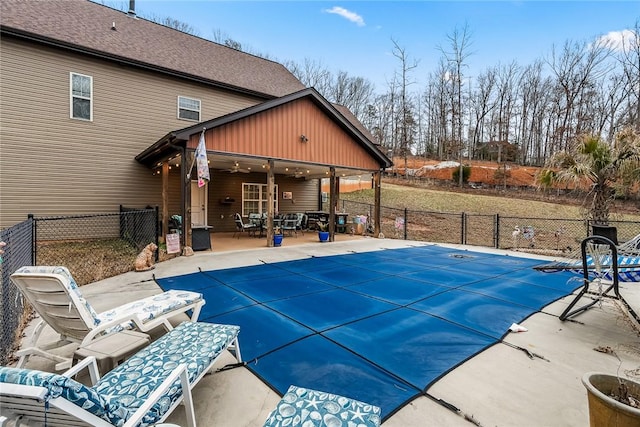 view of swimming pool featuring a patio area, fence, and a fenced in pool