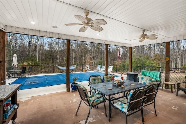 unfurnished sunroom featuring a ceiling fan