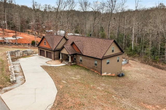 birds eye view of property with a wooded view