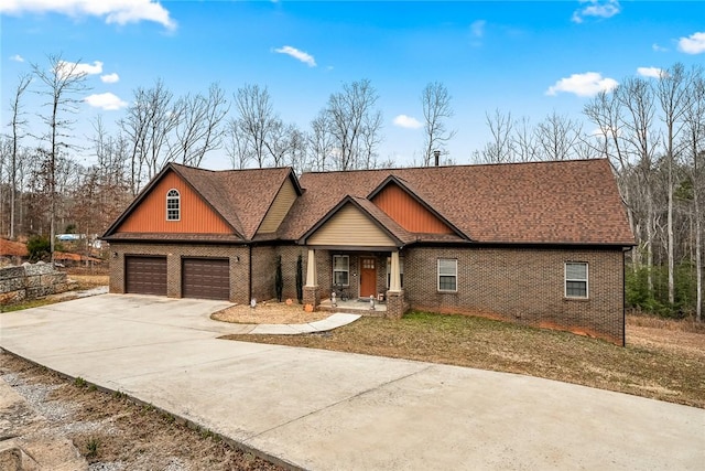 view of front of house featuring a garage, concrete driveway, brick siding, and a shingled roof