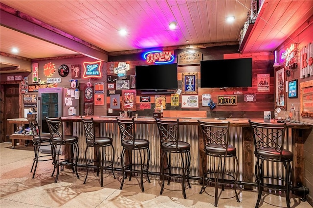 bar featuring wooden ceiling and indoor wet bar