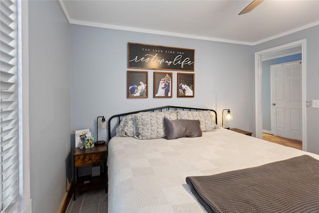 bedroom featuring ceiling fan, ornamental molding, and baseboards