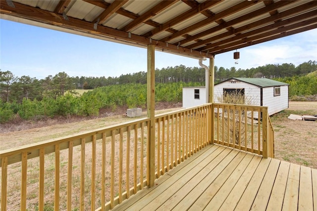 deck with an outdoor structure and a shed