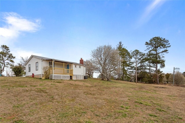 exterior space featuring a lawn and a chimney