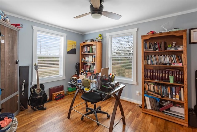 office space with ornamental molding, a healthy amount of sunlight, and wood finished floors