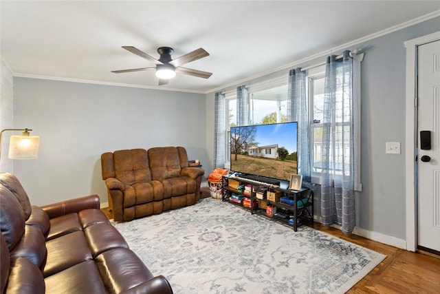 living area featuring a ceiling fan, crown molding, and baseboards