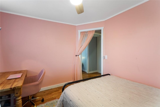 bedroom featuring ornamental molding, wood finished floors, a ceiling fan, and baseboards