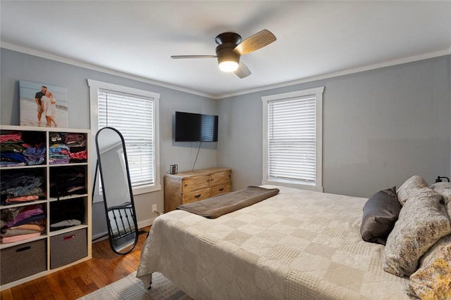 bedroom with ornamental molding, ceiling fan, and wood finished floors