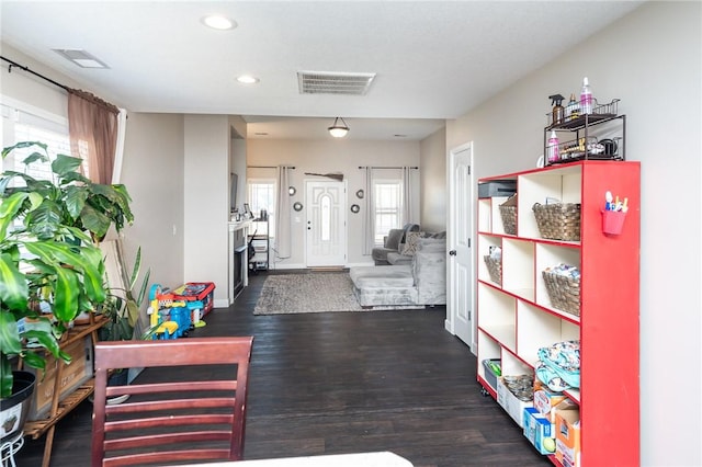 hall featuring baseboards, wood finished floors, visible vents, and recessed lighting