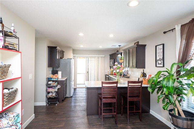 dining area featuring baseboards, dark wood-style flooring, and recessed lighting