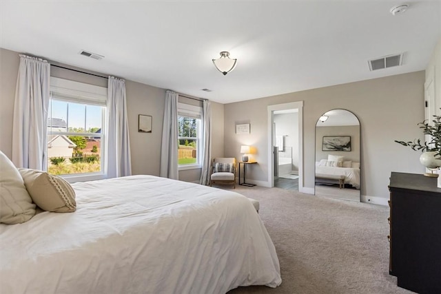 carpeted bedroom with visible vents and baseboards