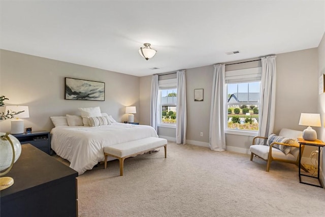 bedroom featuring light carpet, visible vents, and baseboards