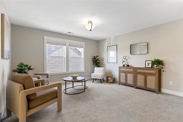 living area with carpet floors, visible vents, and baseboards