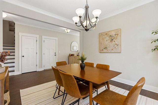 dining area with stairs, crown molding, wood finished floors, and baseboards