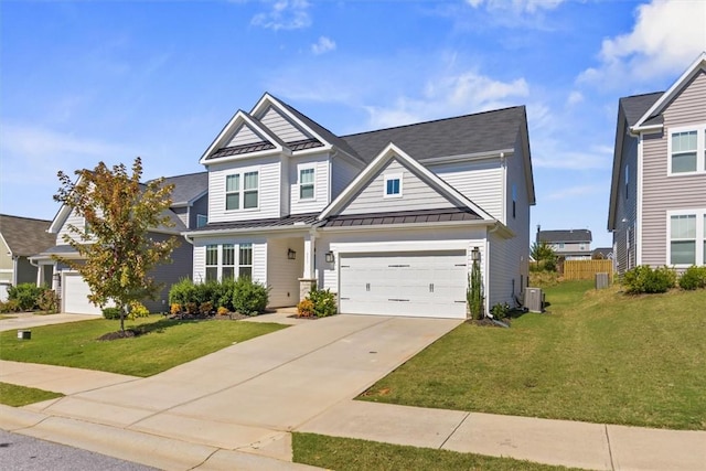 craftsman house with metal roof, central AC unit, driveway, a standing seam roof, and a front yard