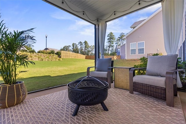 view of patio featuring an outdoor fire pit and fence