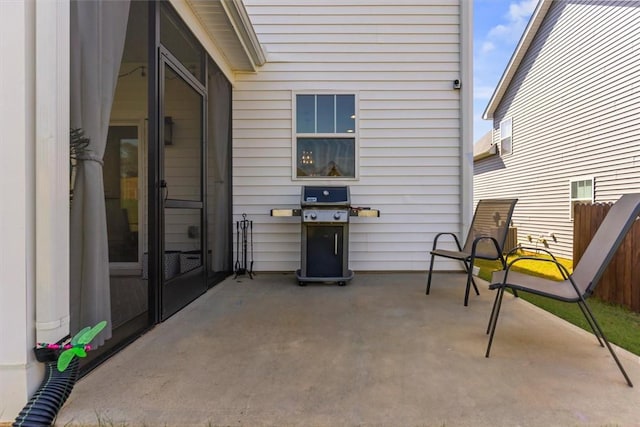 view of patio featuring grilling area and fence