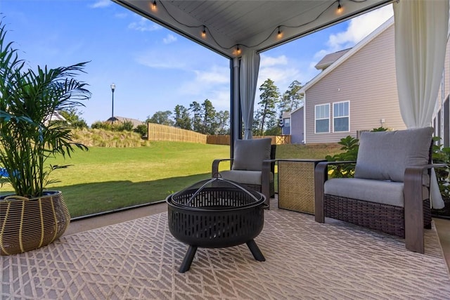 view of patio / terrace featuring an outdoor fire pit and fence