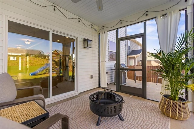 sunroom featuring a ceiling fan