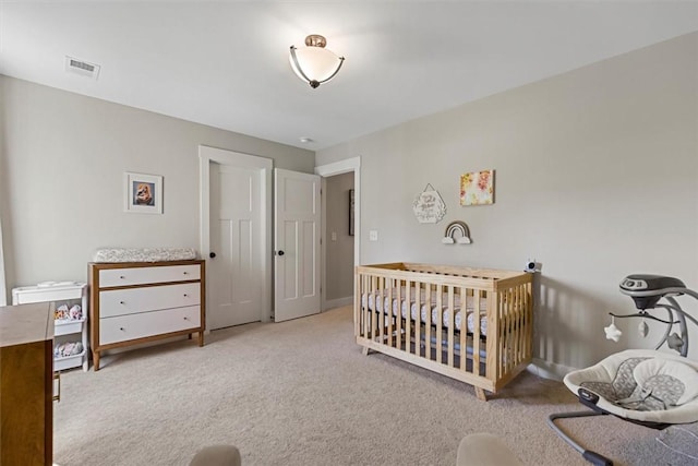 bedroom featuring baseboards, visible vents, and carpet flooring