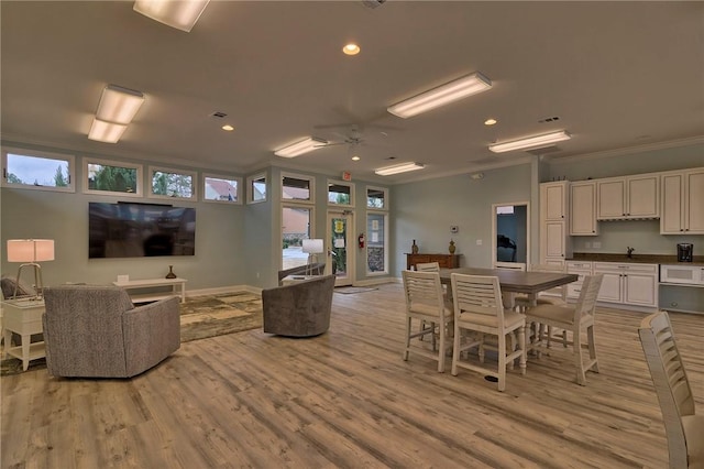 dining space with baseboards, ceiling fan, ornamental molding, light wood-type flooring, and recessed lighting