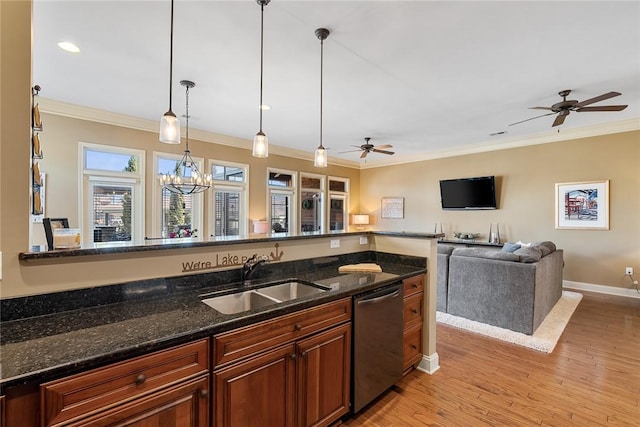 kitchen with ornamental molding, light wood-type flooring, a sink, and dishwasher