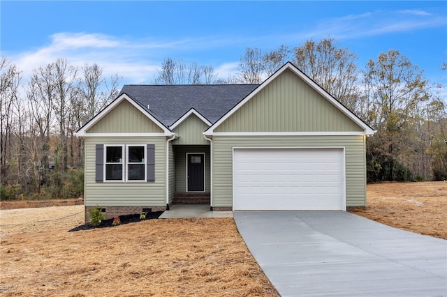 ranch-style home with a shingled roof, crawl space, concrete driveway, and an attached garage