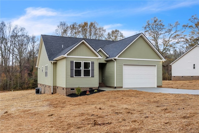 view of front of home with roof with shingles, an attached garage, central AC unit, crawl space, and driveway